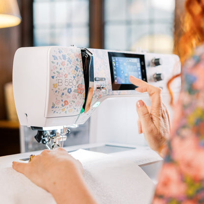 Person using a modern sewing machine in a well-lit room