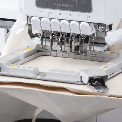 Embroidery machine with needle plate on a white background