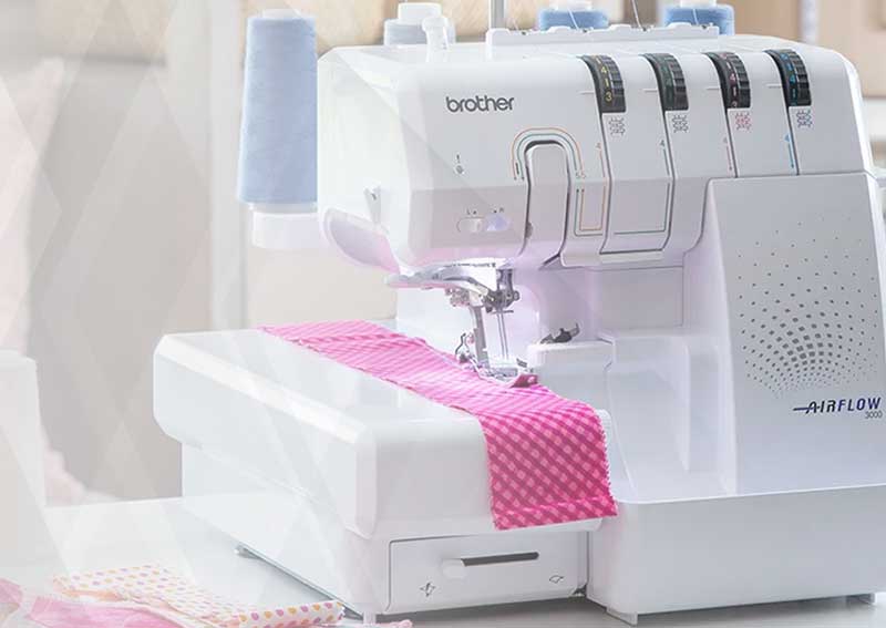 Overlocker machine on sewing table